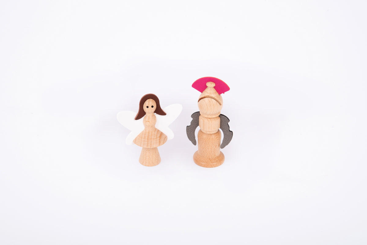 Two wooden characters: a winged fairy figure and a nutcracker soldier