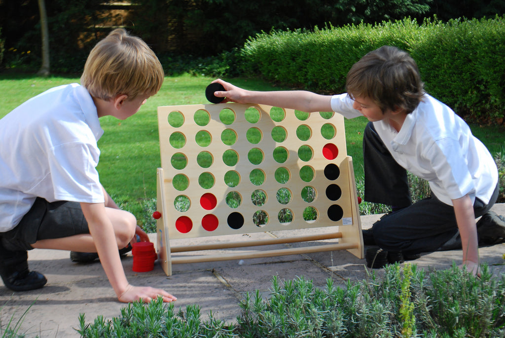 Wooden Connect Four board with green disc pattern and side ledge