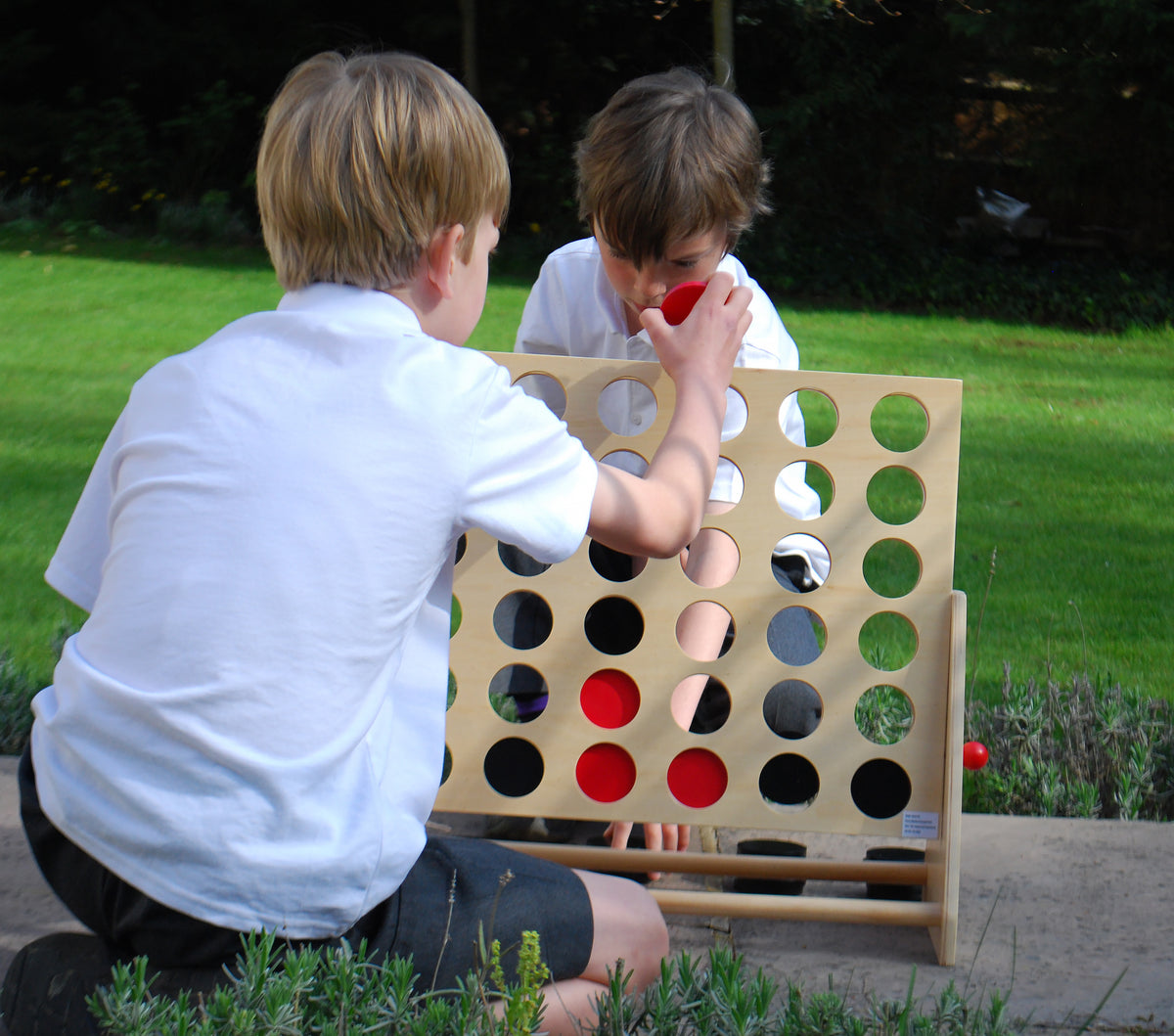 Wooden Connect Four board with colorful round discs and open slots