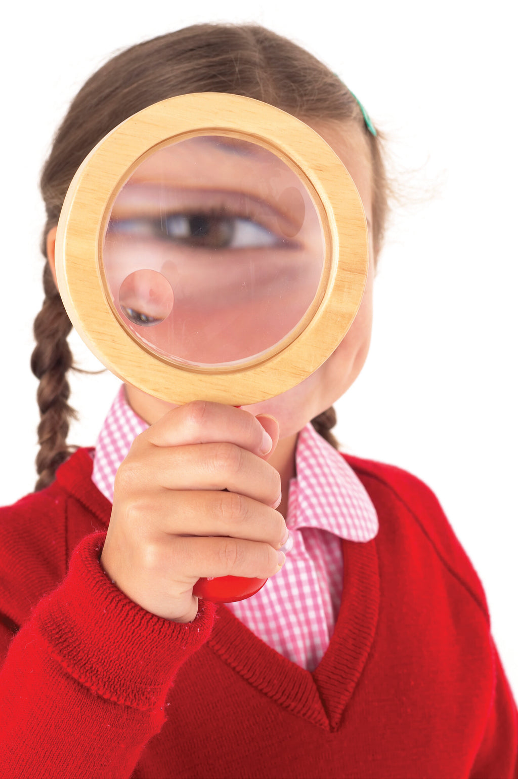 Child holding a wooden hand lens with circular magnifying glass