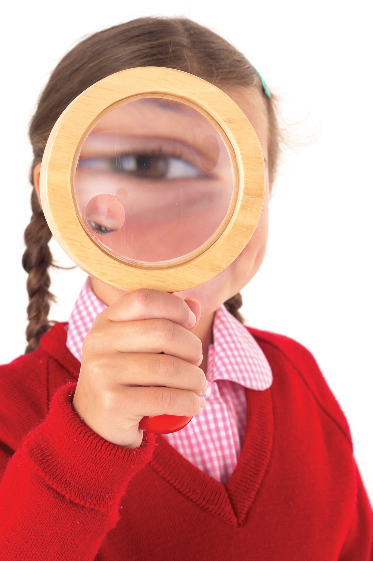 Child holding a wooden hand lens with circular magnifying glass
