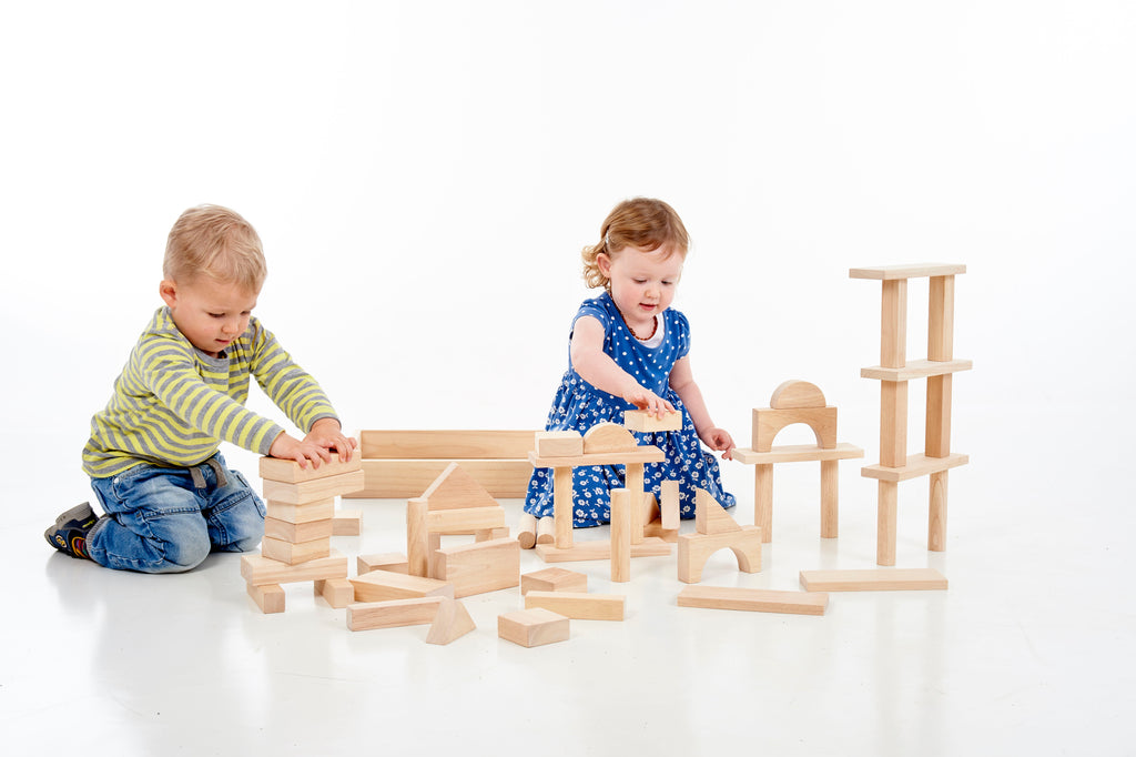 Wooden jumbo block set with children building tall block structures