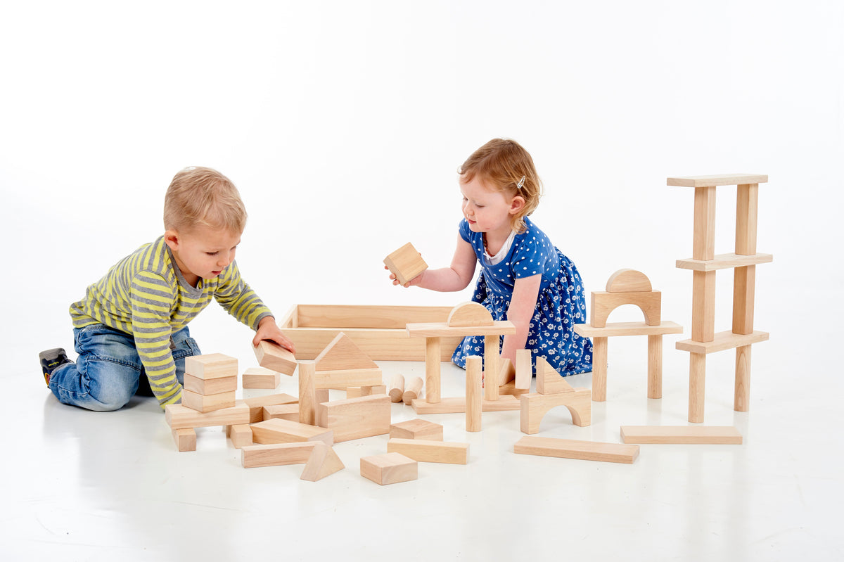 Wooden jumbo block set as two children arrange large wooden blocks and ramps