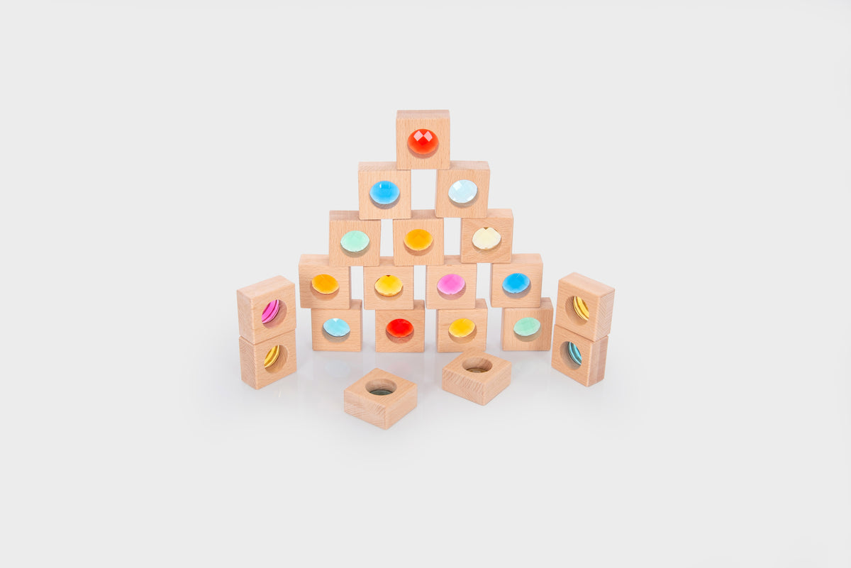 Wooden kaleidoscope blocks set with stacked square pieces and circular colored inlays