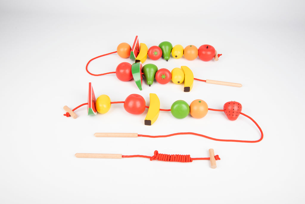 Wooden lacing fruit beads with multiple red cords, including watermelon and citrus shapes