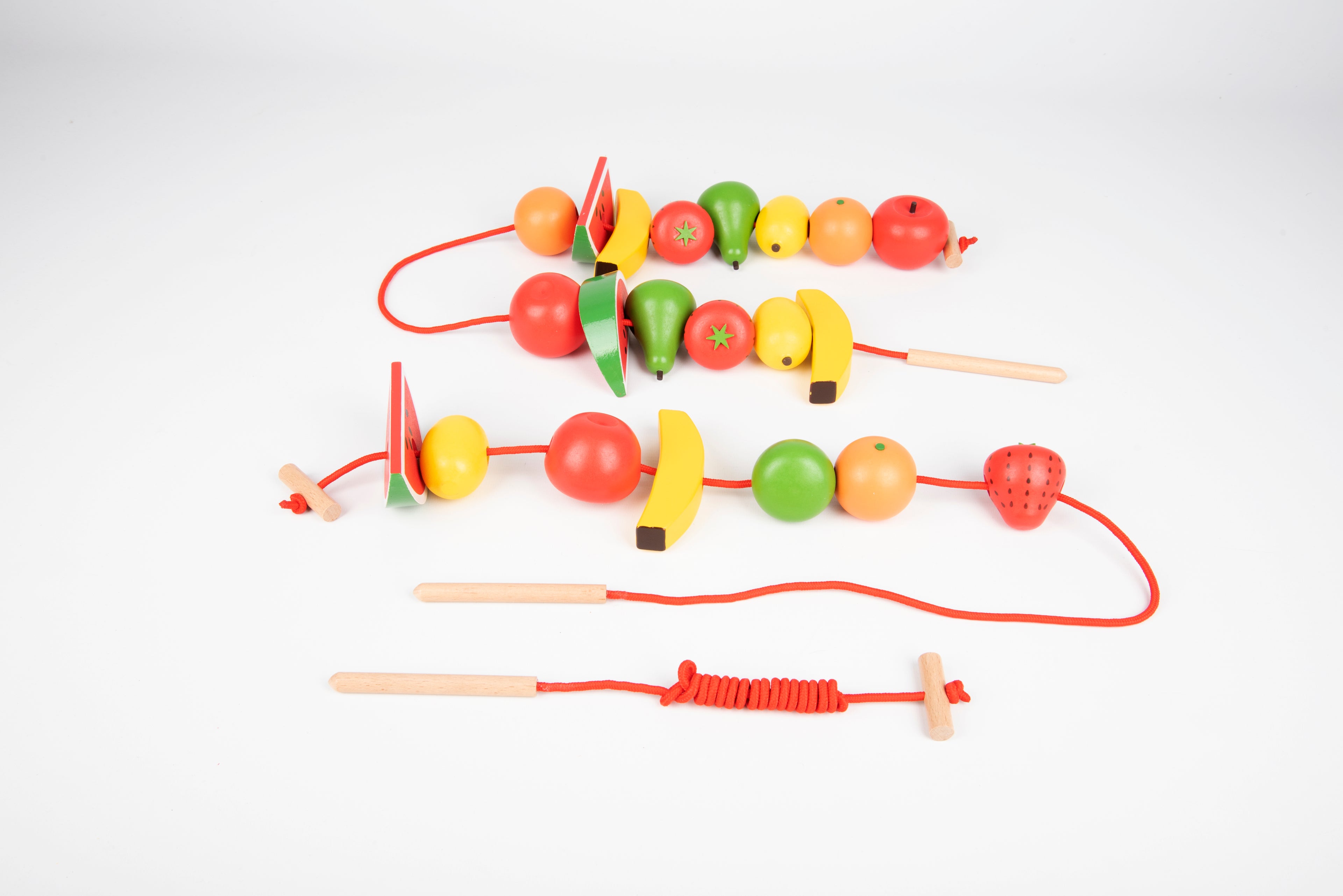 Wooden lacing fruit beads with multiple red cords, including watermelon and citrus shapes