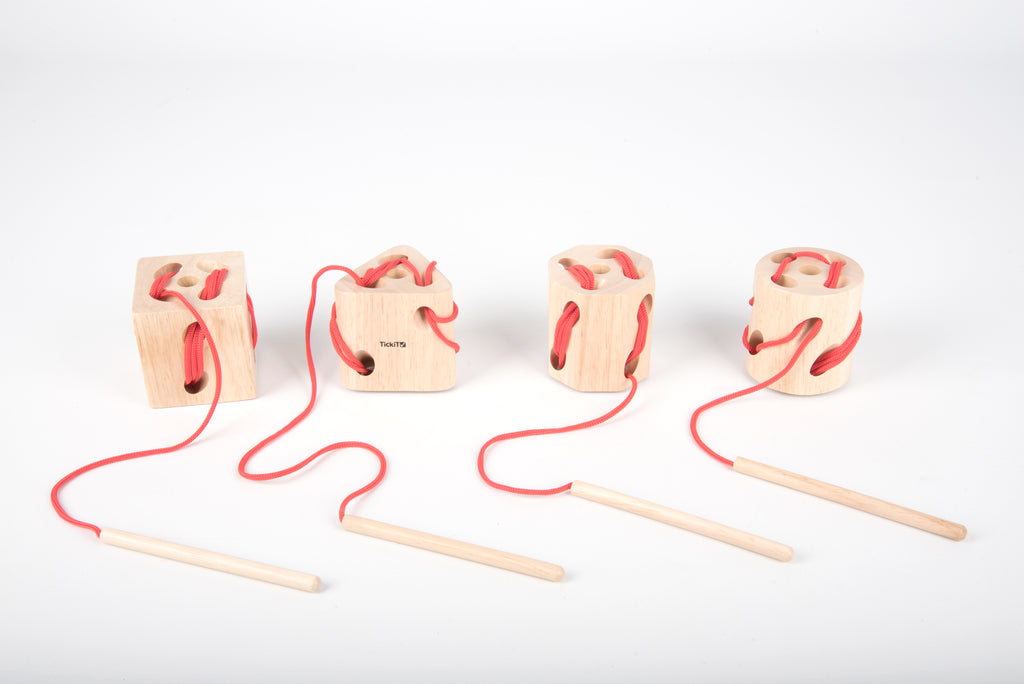 Wooden lacing shape blocks with red laces and wooden dowel lacing tools
