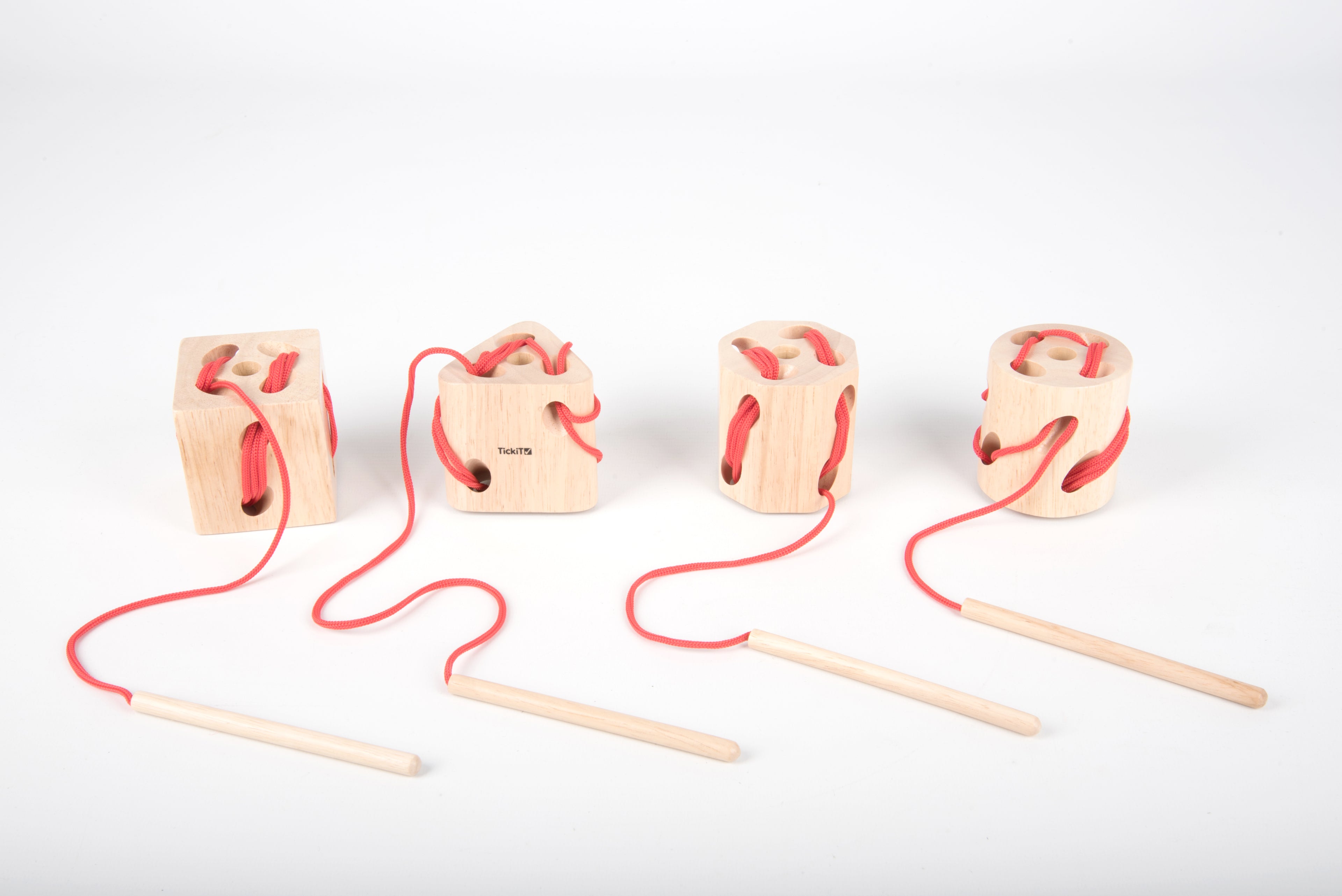 Wooden lacing shape blocks with red laces and wooden dowel lacing tools