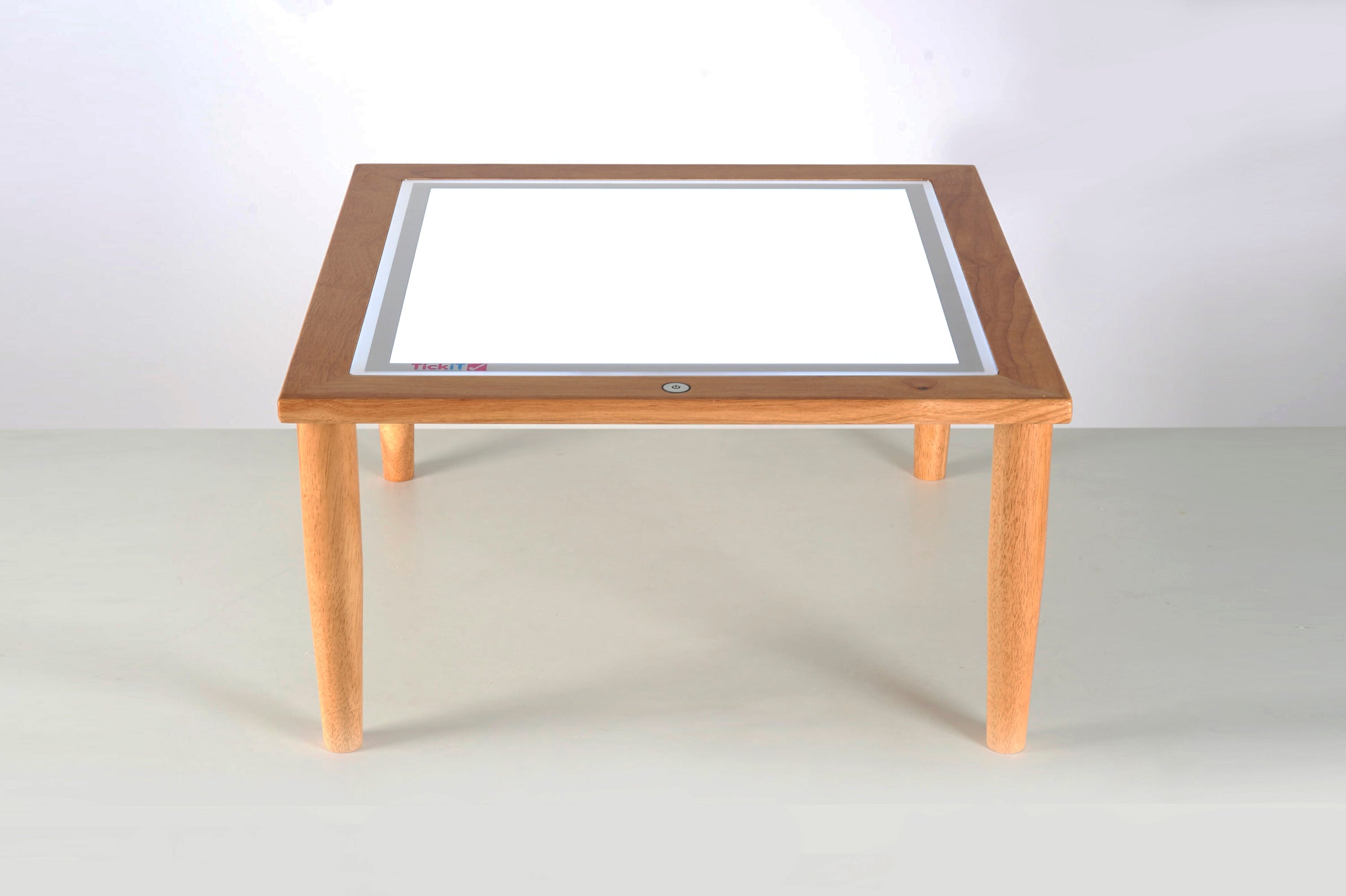 Wooden light table with clear rectangular light panel and four short legs