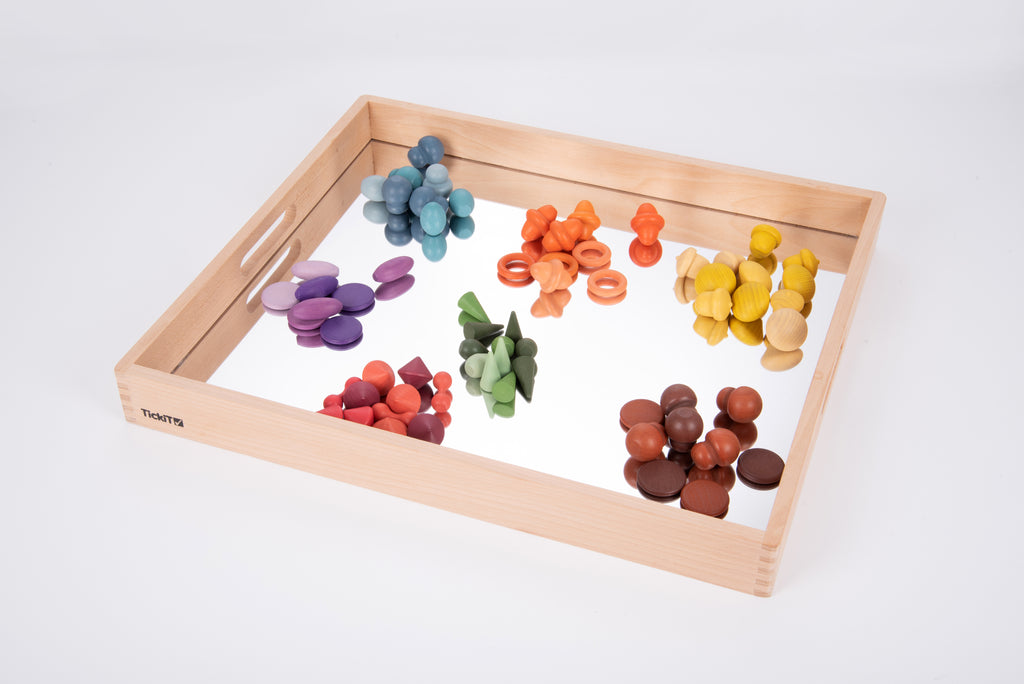 Wooden mirror tray with light wood frame and colorful wooden pegs on reflective base