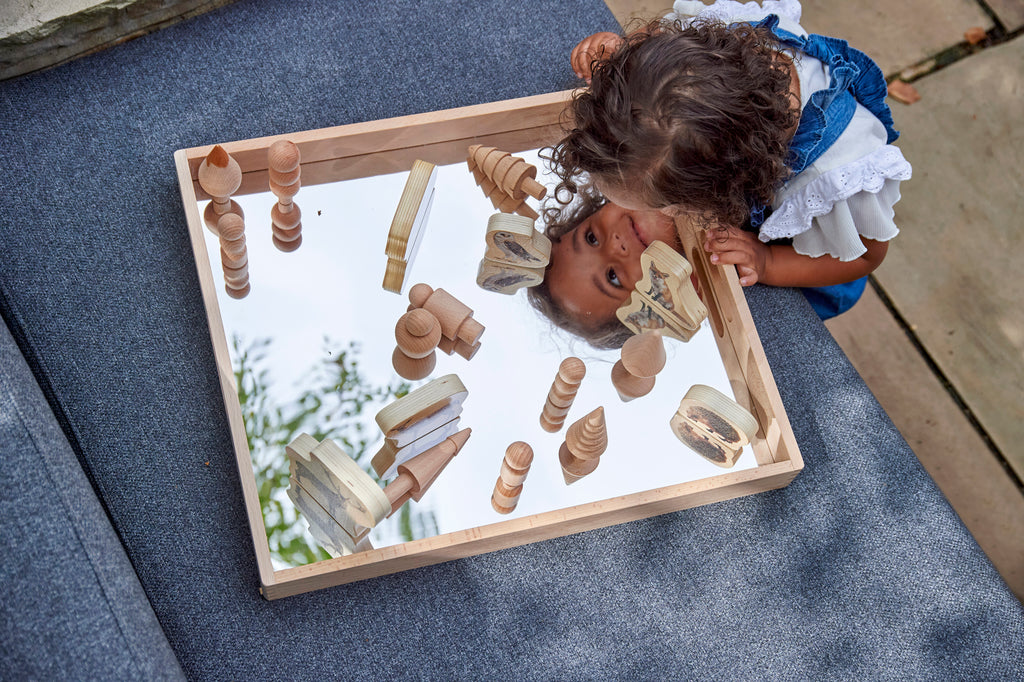 Wooden mirror tray with light wood frame and reflective center for play