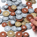 Wooden play money coin set with pence and pound denominations, one coin held by hand