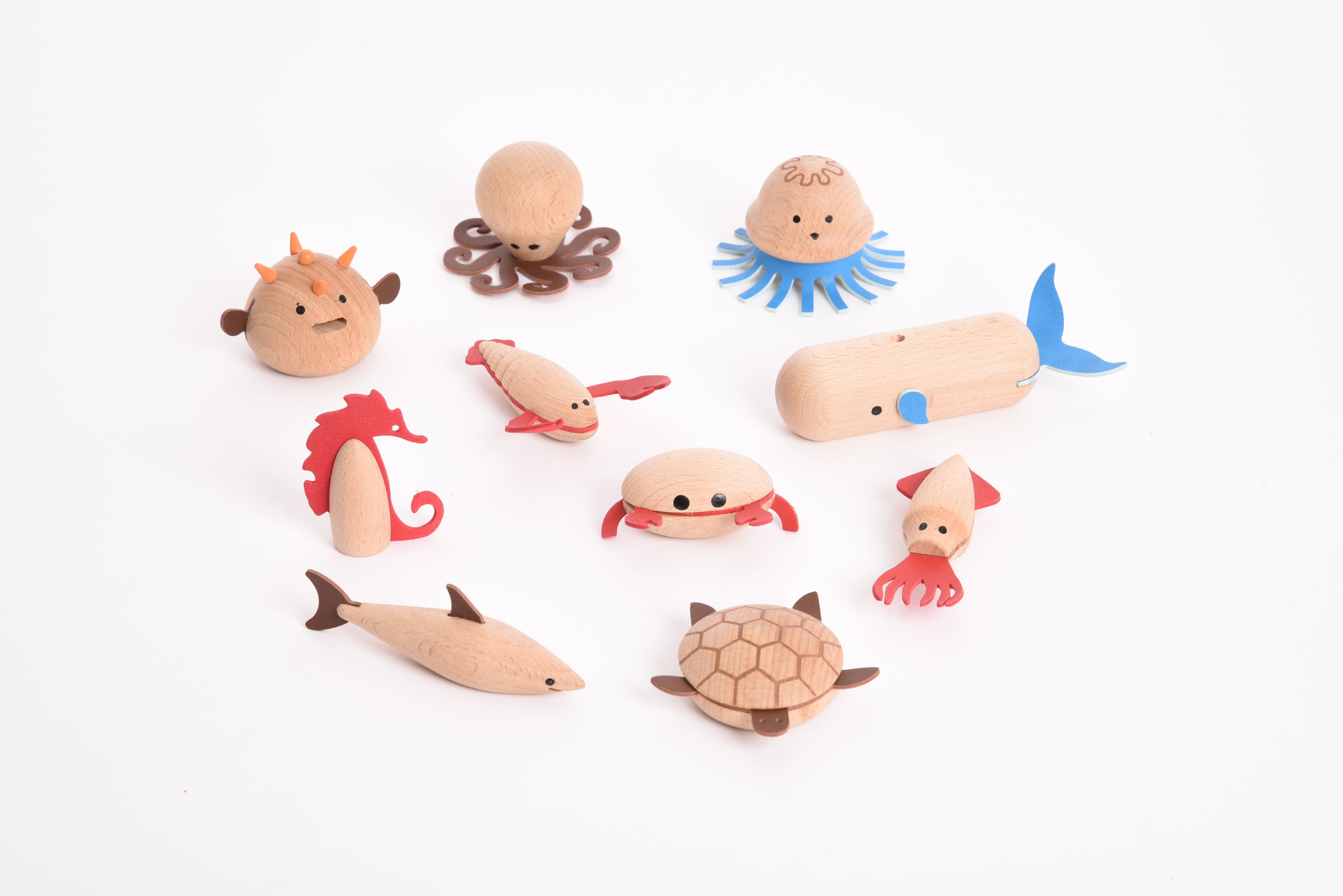 Assorted wooden sea creature figurines: crab, jellyfish, whale, octopus, and turtle