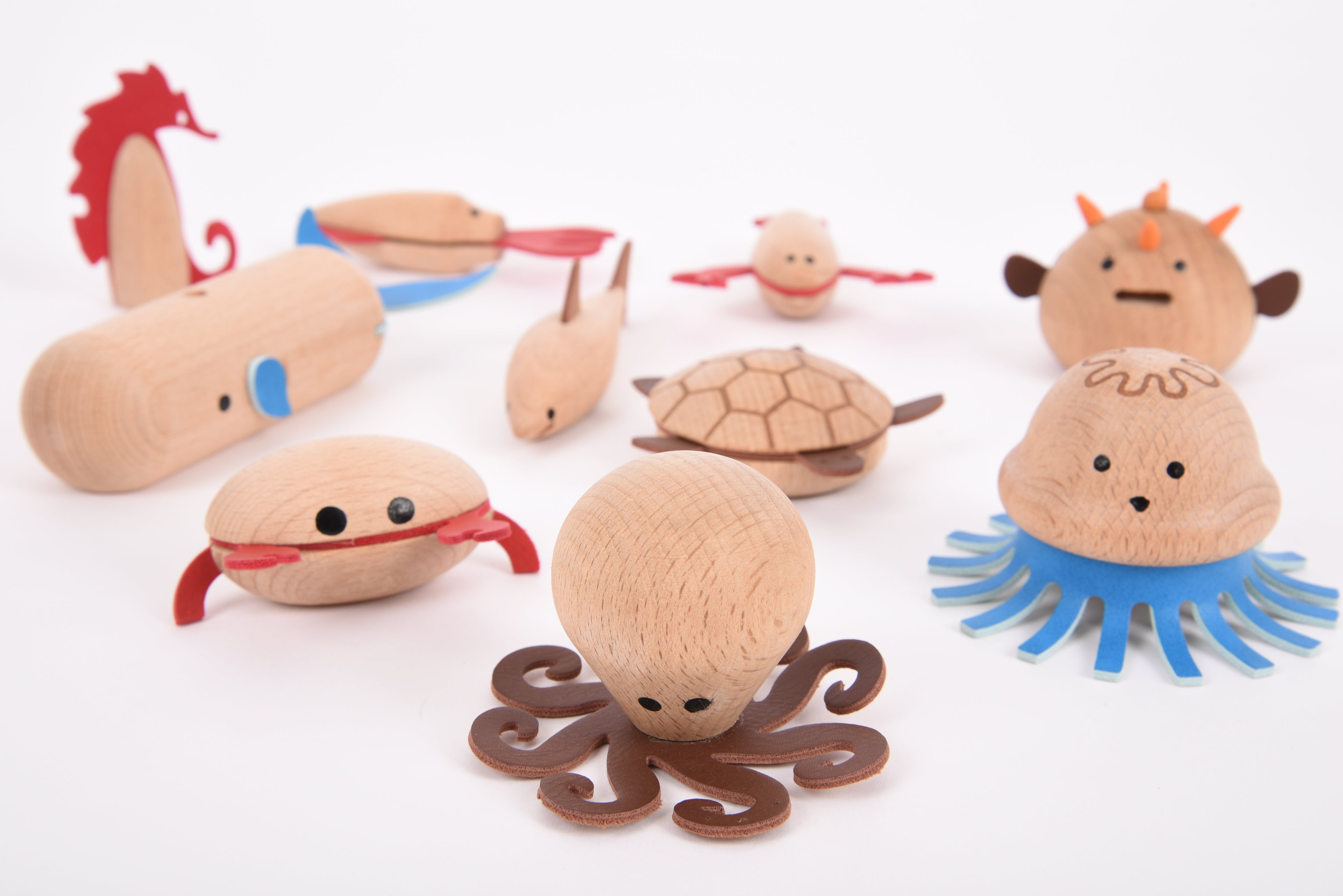 Assorted wooden sea creature figurines including whale, crab, sea turtle, jellyfish, and seahorse