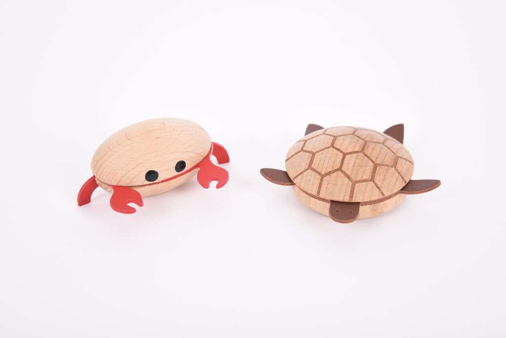 Wooden sea creature figurines close-up: red crab and brown turtle