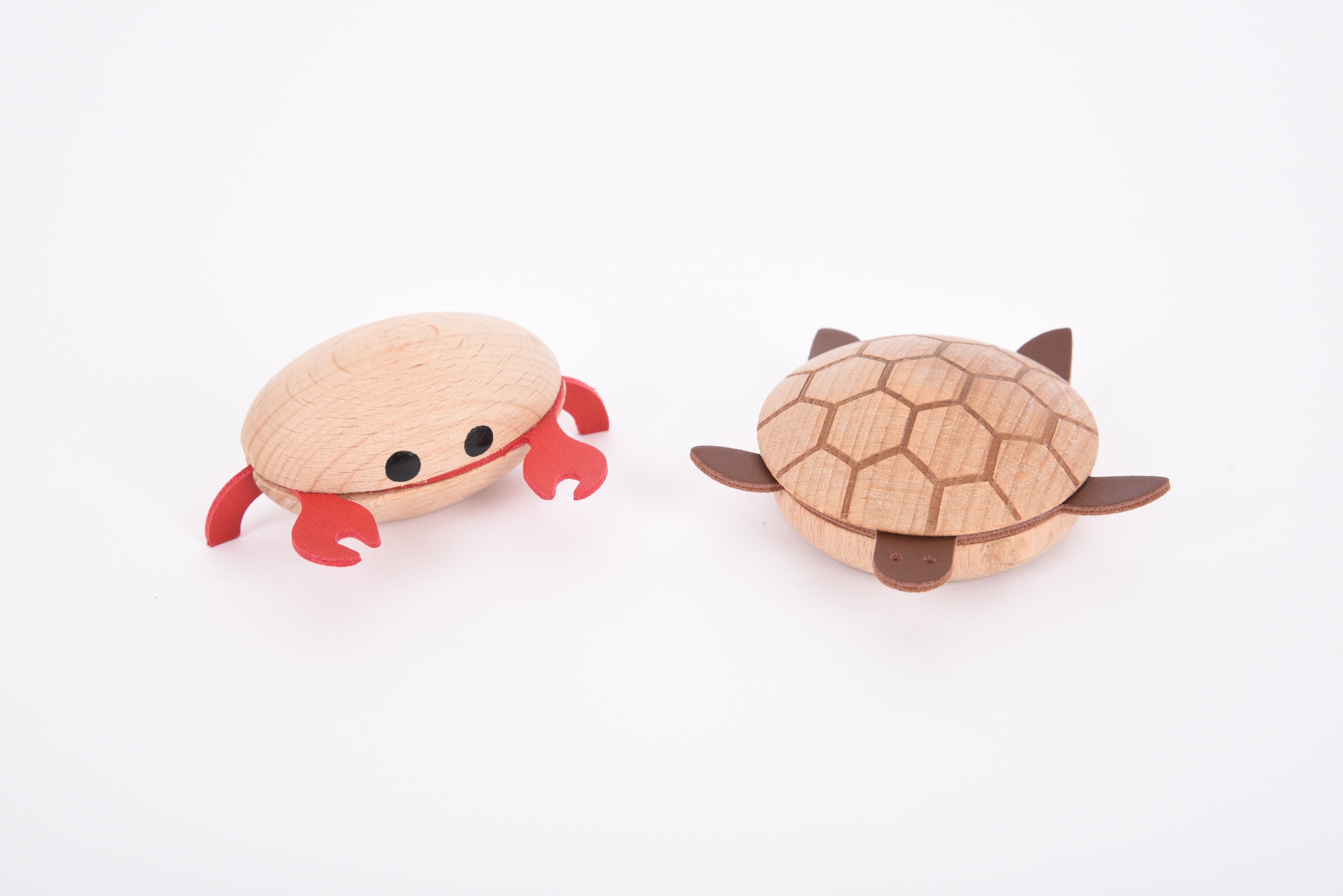 Wooden sea creature figurines close-up: red crab and brown turtle