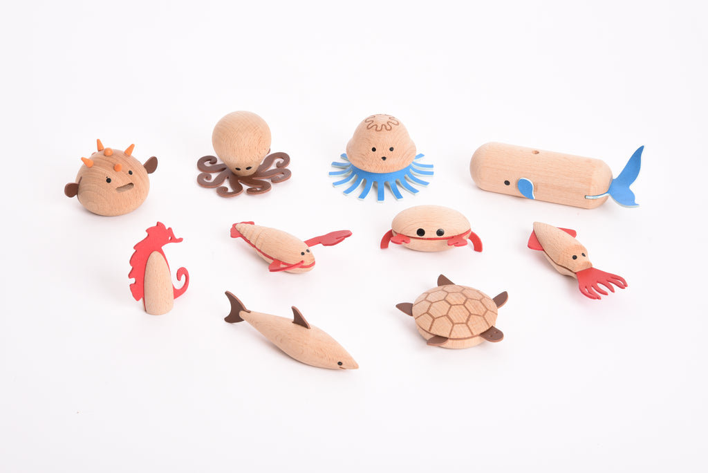 Assorted wooden sea creature figurines: octopus, jellyfish, turtle, fish, and more