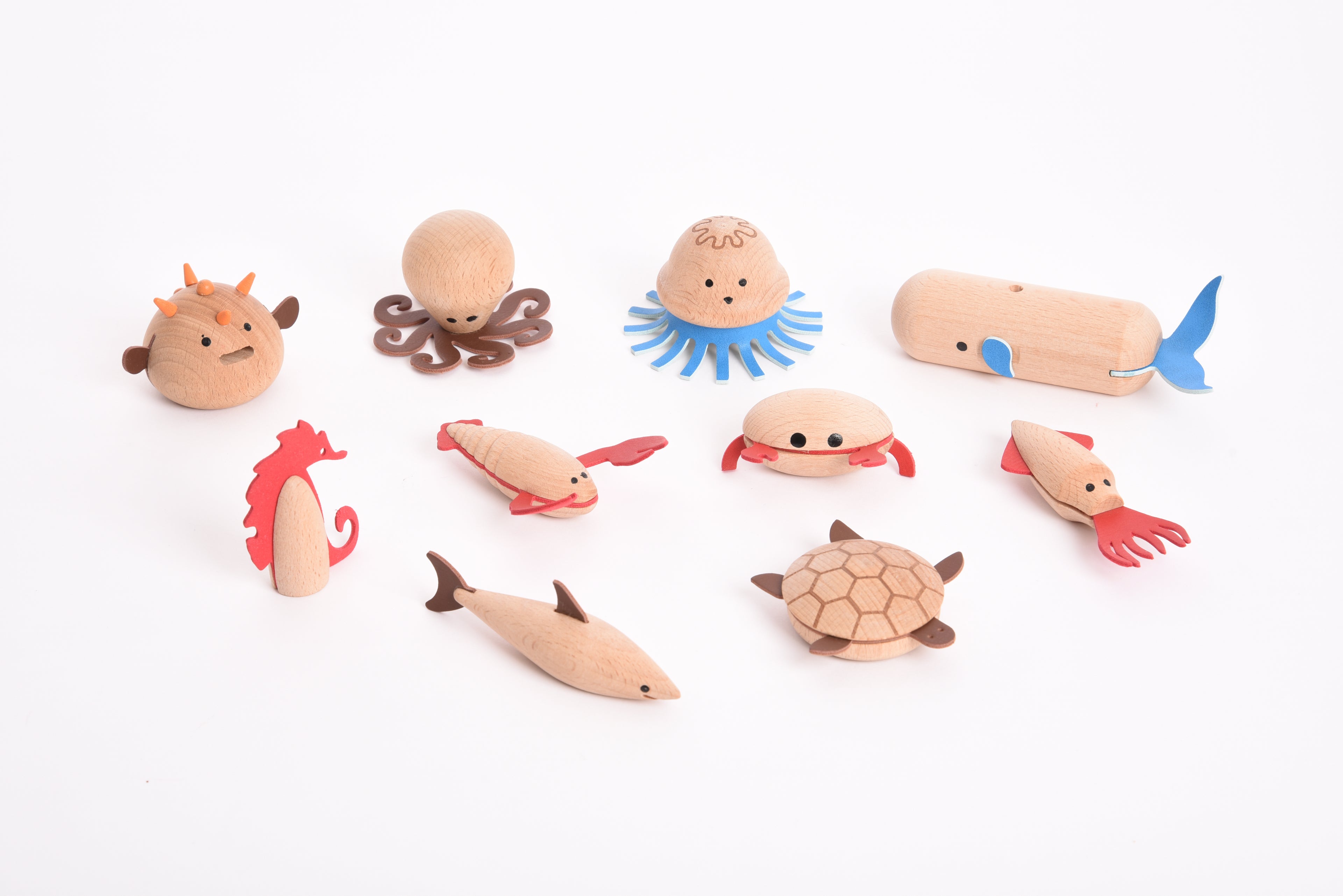 Assorted wooden sea creature figurines: octopus, jellyfish, turtle, fish, and more