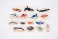 Assorted wooden sea animal blocks, including dolphins, sharks, jellyfish and crab