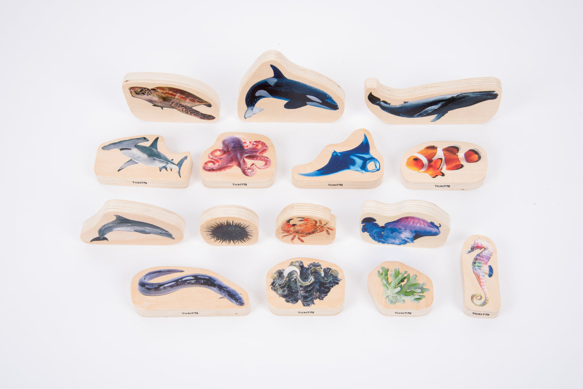 Assorted wooden sea animal blocks, including dolphins, sharks, jellyfish and crab