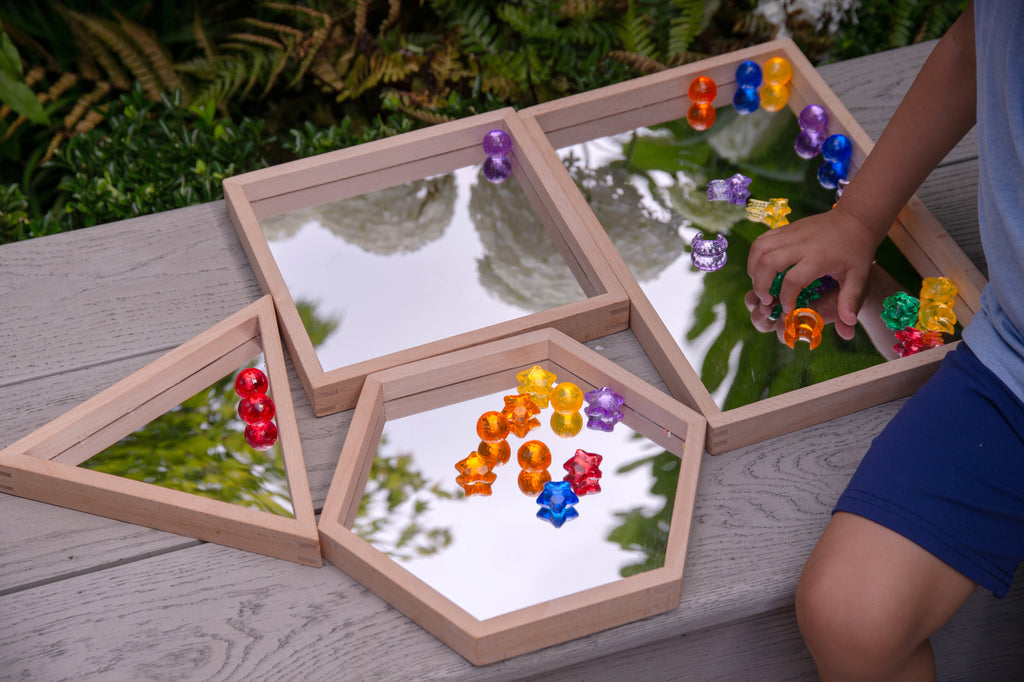 Wooden mirror tray set of 4 with light wood frames and clear mirrors, filled with colorful beads