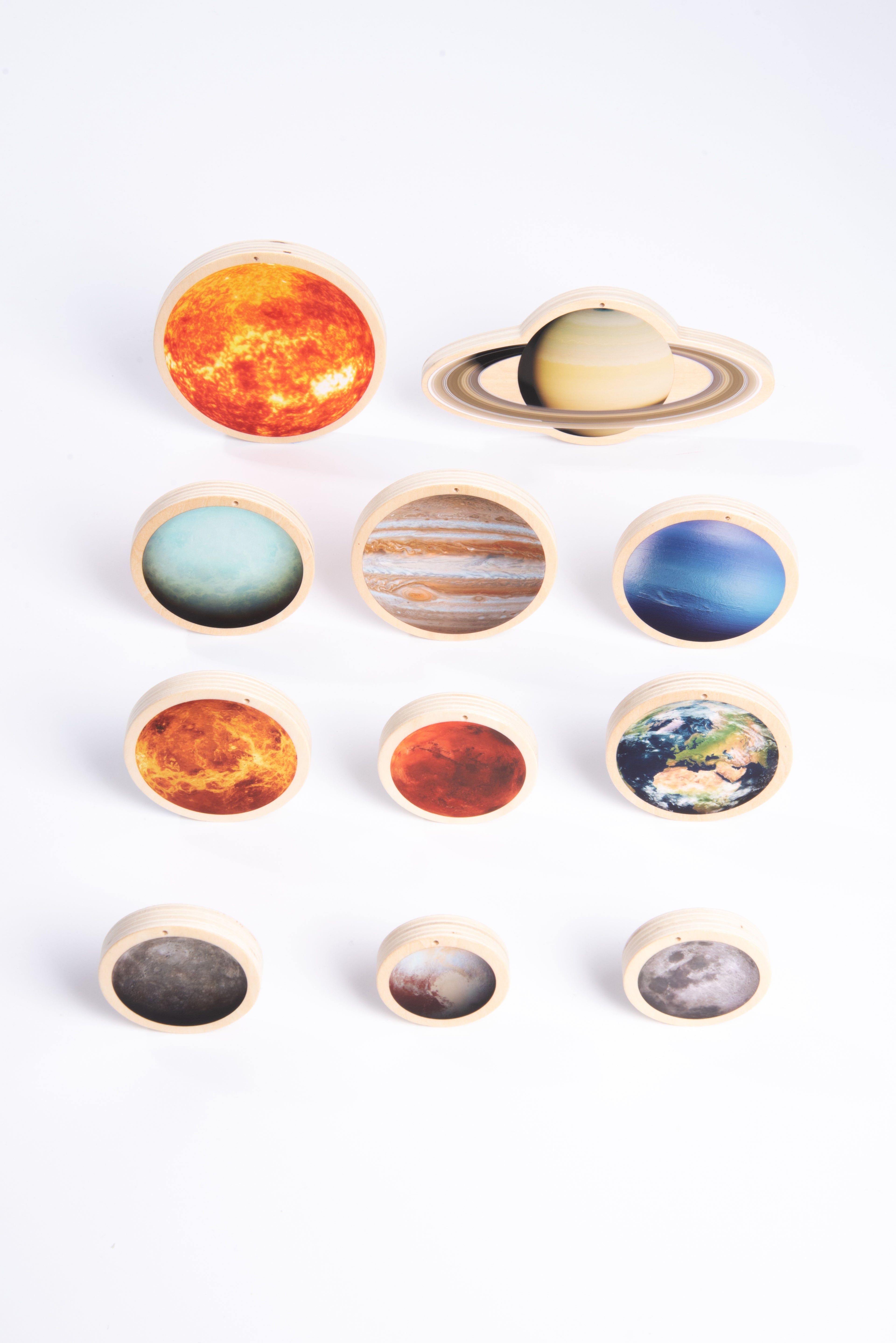 Wooden solar system discs set with a Saturn ring disc, Earth, and several smaller moons