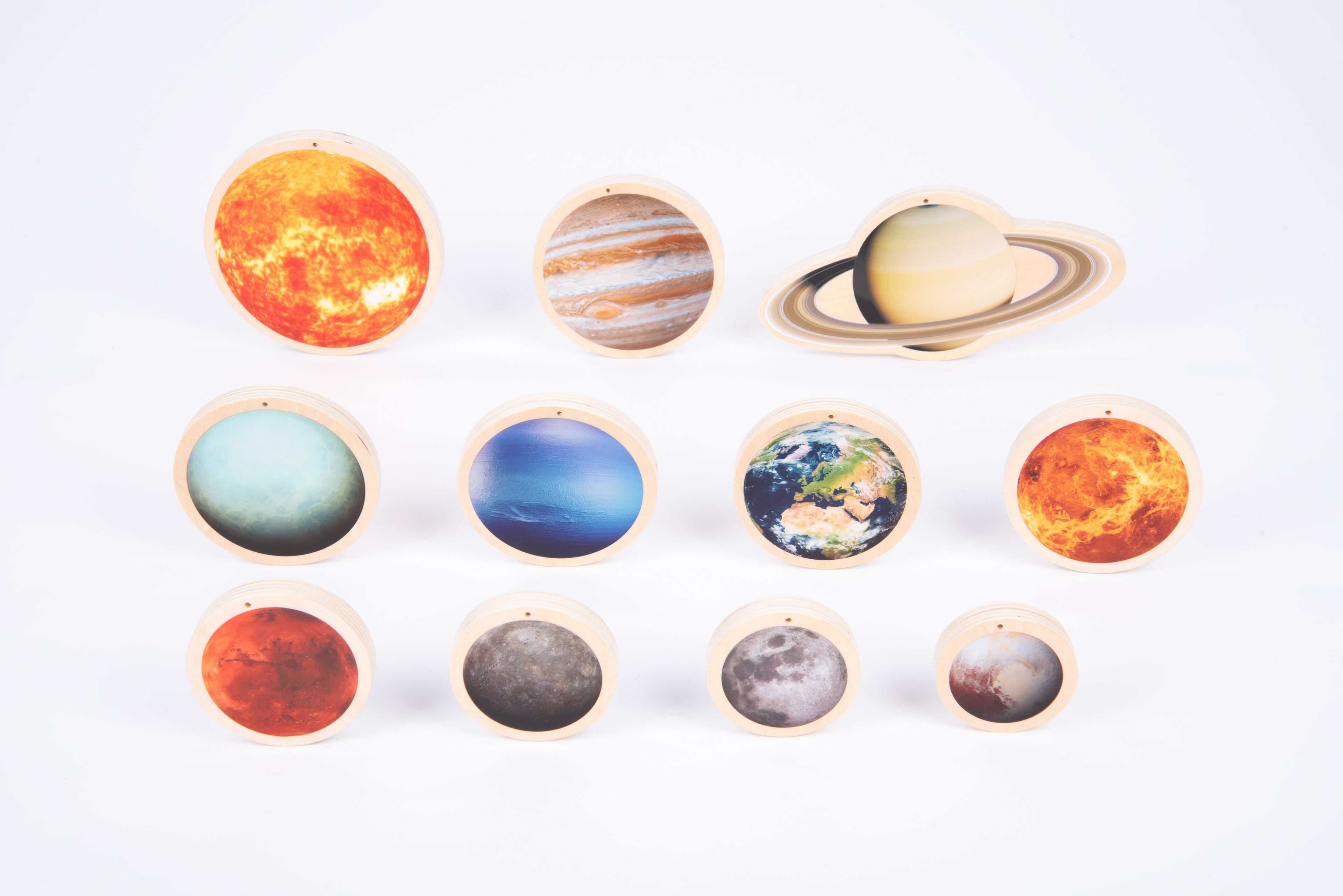 Wooden solar system discs arranged in a semicircle, showing multiple planet and moon faces