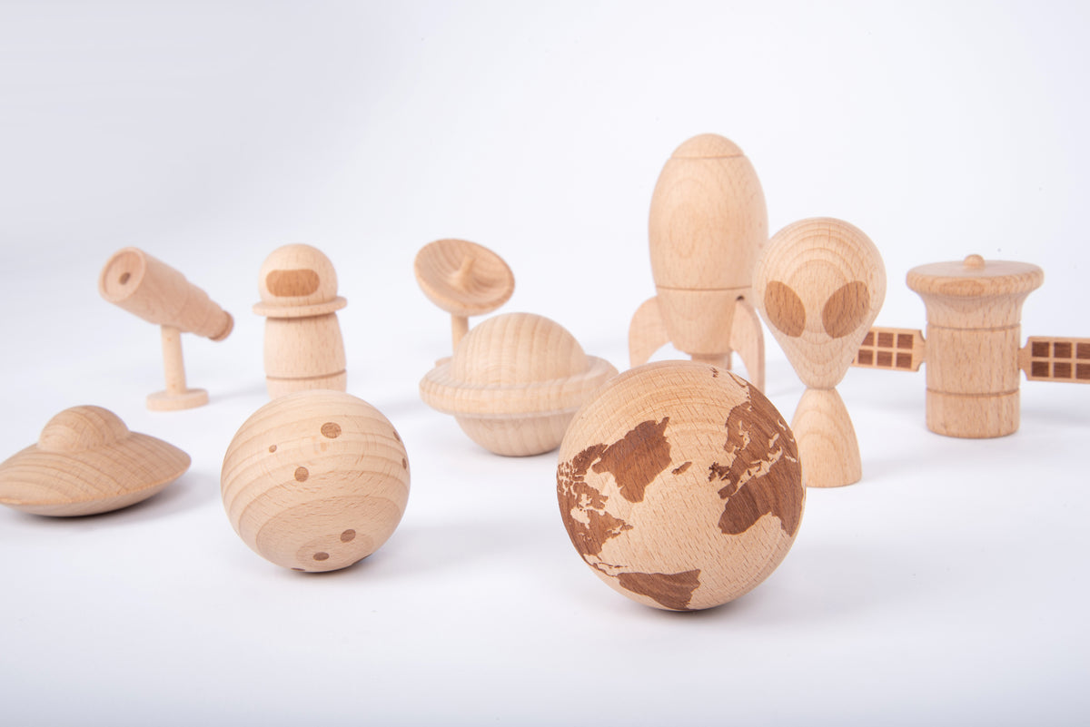 Wooden space play set with astronaut, globe planet, rover and rocket parts in light wood