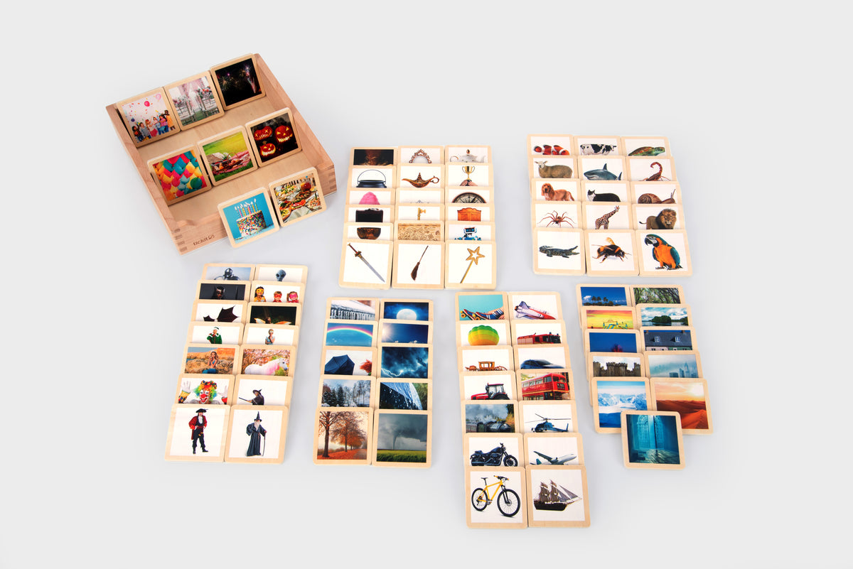 Large set of wooden photo story tiles featuring figures, bicycles, and landscape scenes