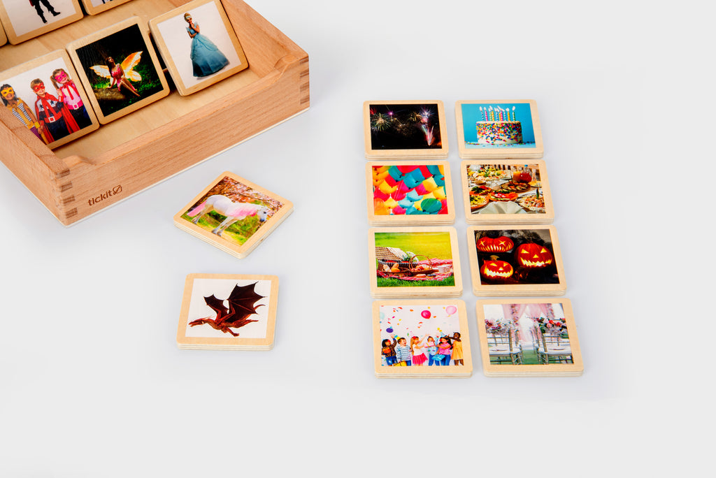 Wooden story tile box with photo tiles and a leaf-shaped card, colorful scenes