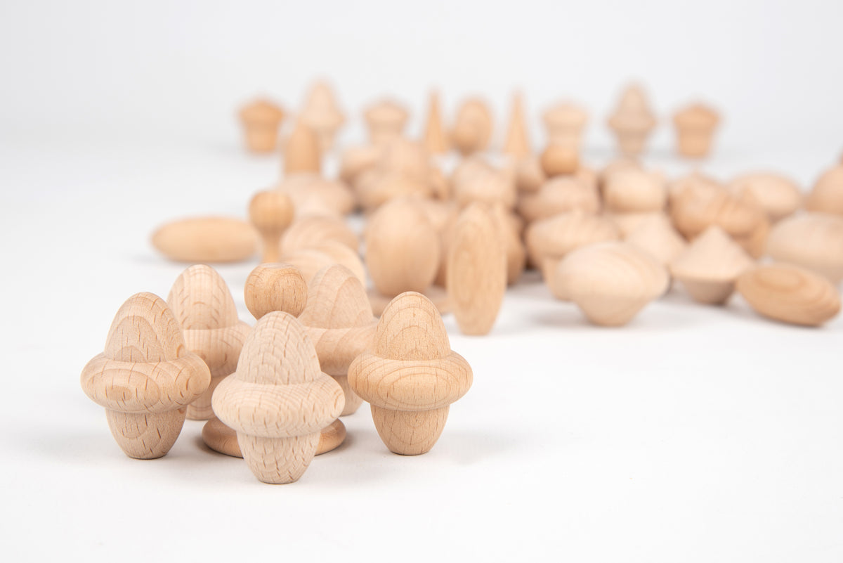Natural wooden acorn-shaped figures with pointed caps