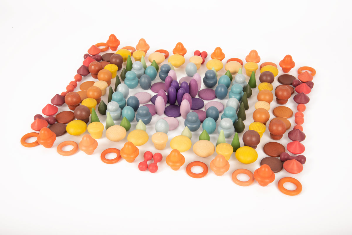 Colorful wooden peg pieces scattered together, with ring ends in orange, blue, and more.