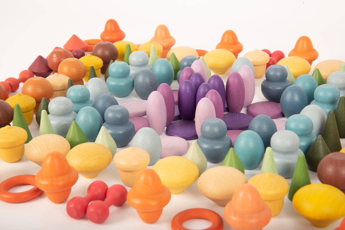 Dense close-up of multicolor wooden peg pieces in rows with orange and purple details.