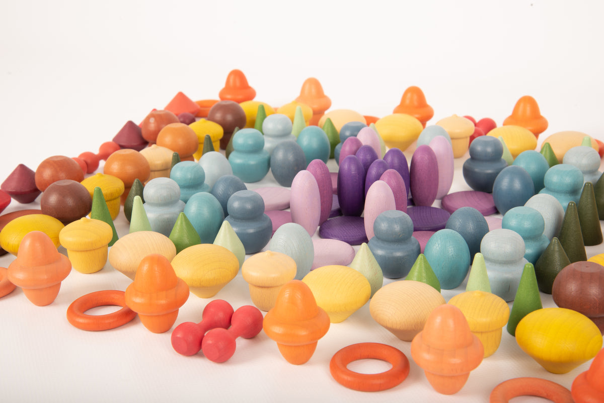 Close-up of multicolor wooden peg pieces and ring connectors densely packed together.