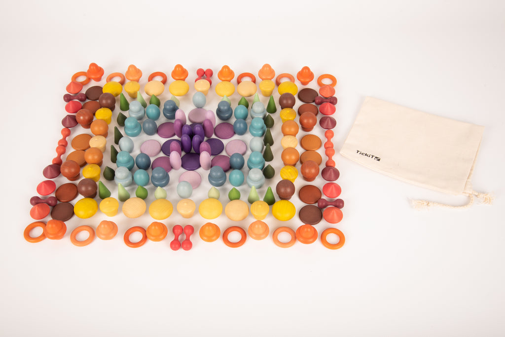 Colorful wooden peg grid pattern with scattered pieces and a cream drawstring pouch.