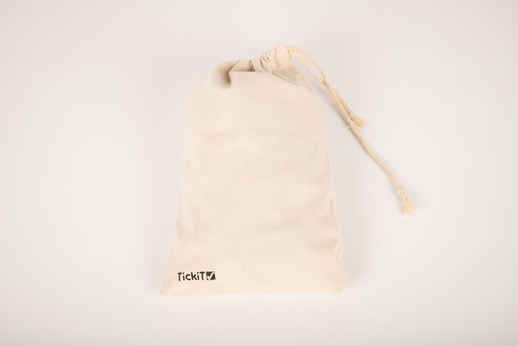 Cream drawstring pouch with tassel and TikiTi logo on the lower front.