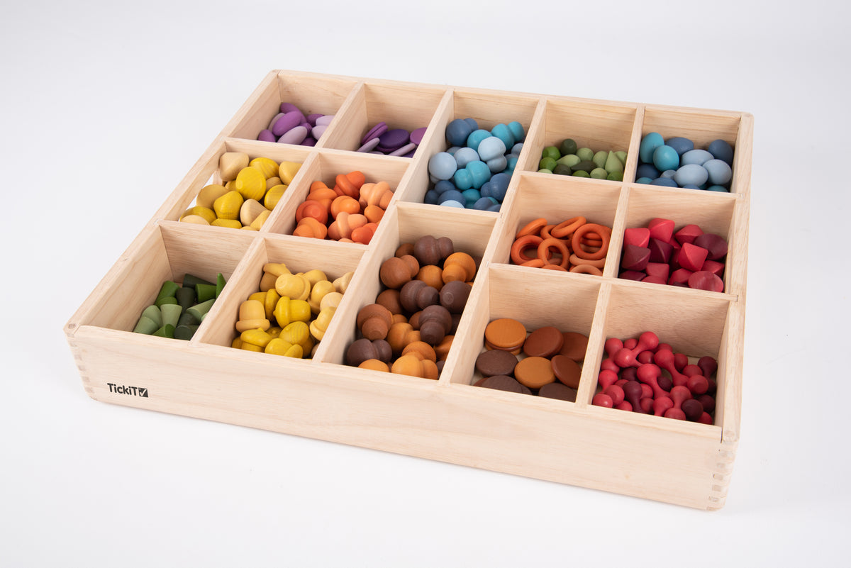 Wooden sorting tray with 14 compartments filled with colorful wooden beads