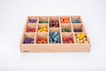 Wooden sorting tray with 14 compartments filled with colorful wooden pieces