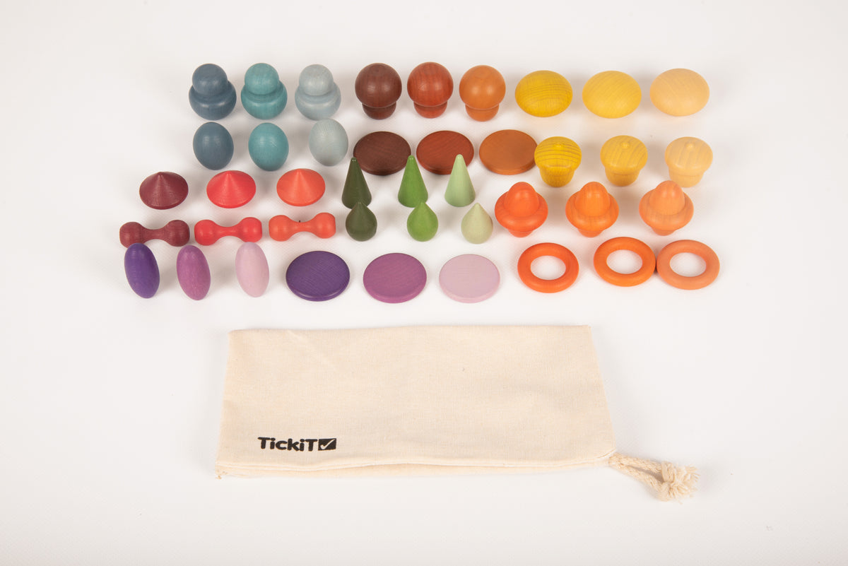 Wooden color pegs and rings, arranged with open cream TickiT pouch
