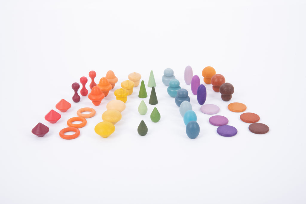 Assorted wooden pegs and rings grouped by colors across the surface