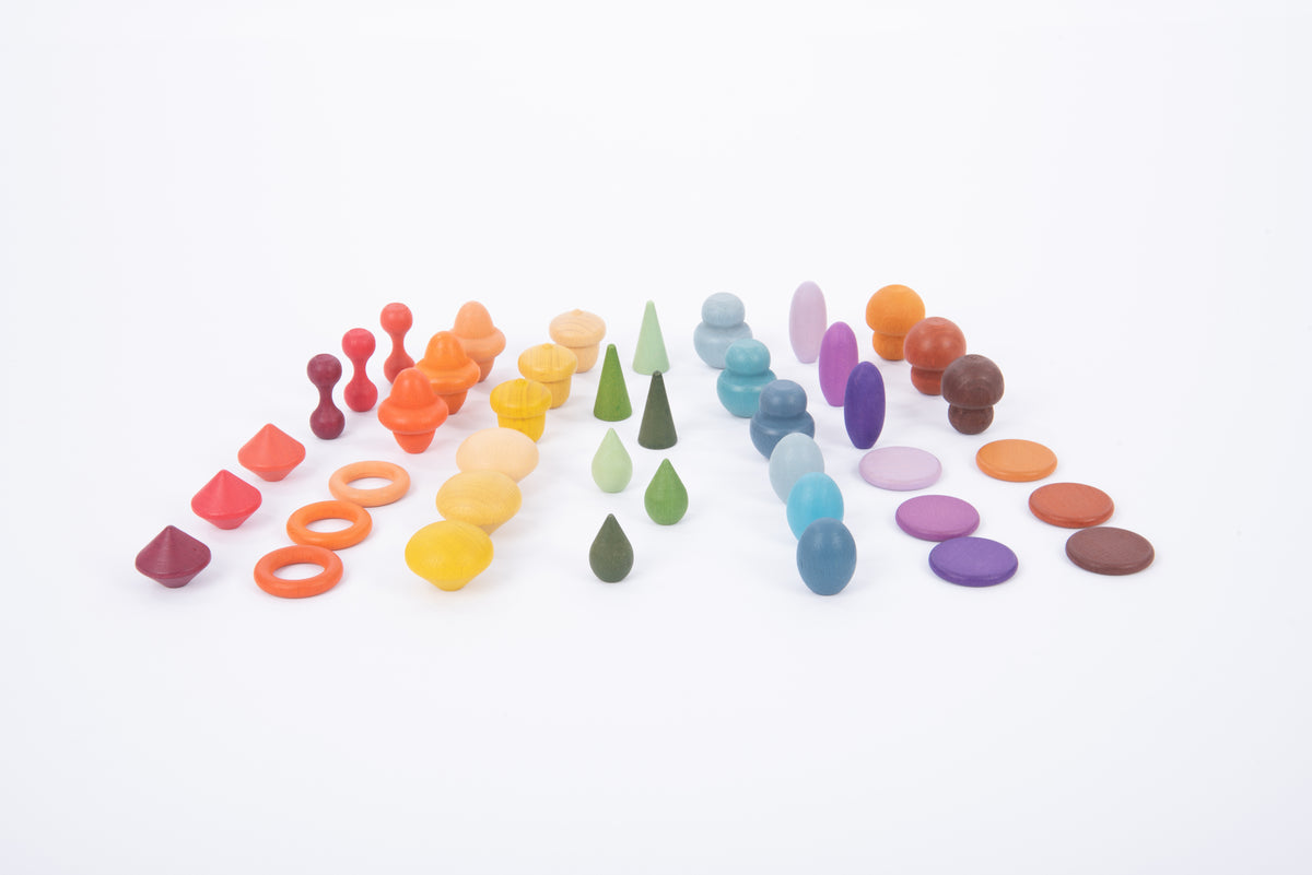 Assorted wooden pegs and rings grouped by colors across the surface