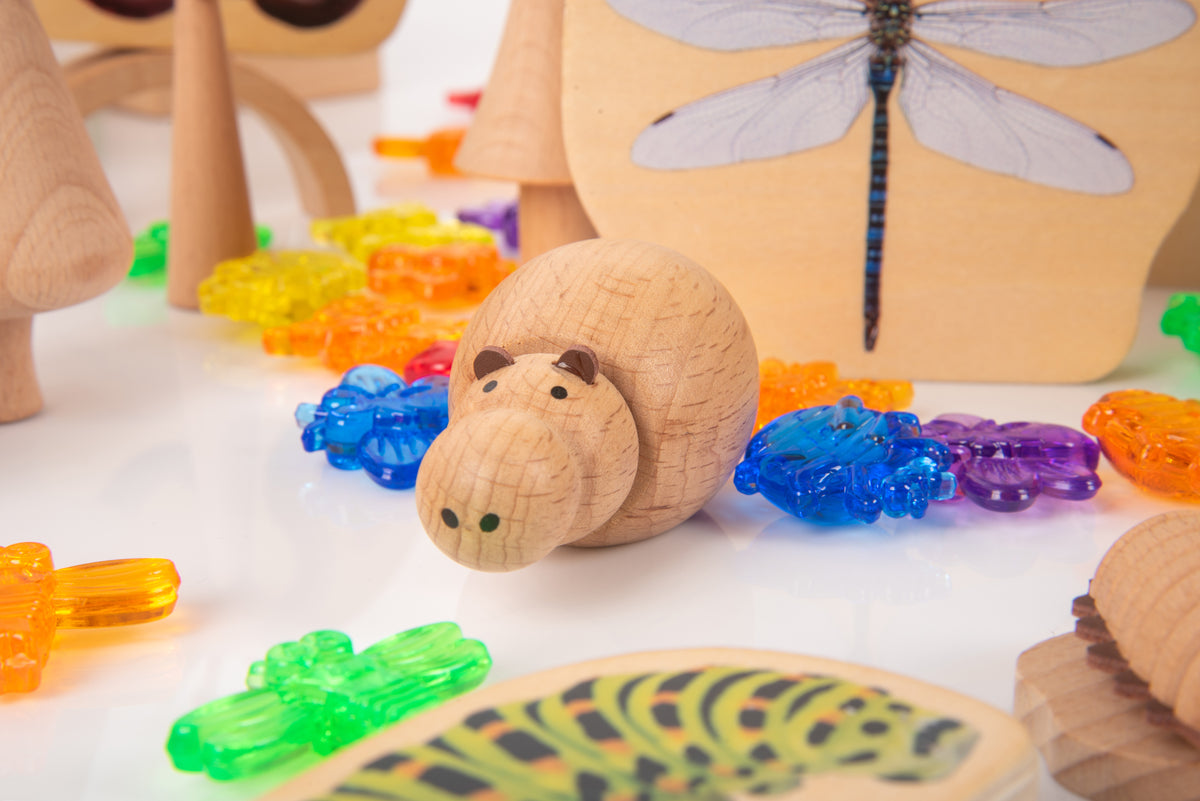 Wooden insect-themed rolling figure with bead tracks and dragonfly-shaped board