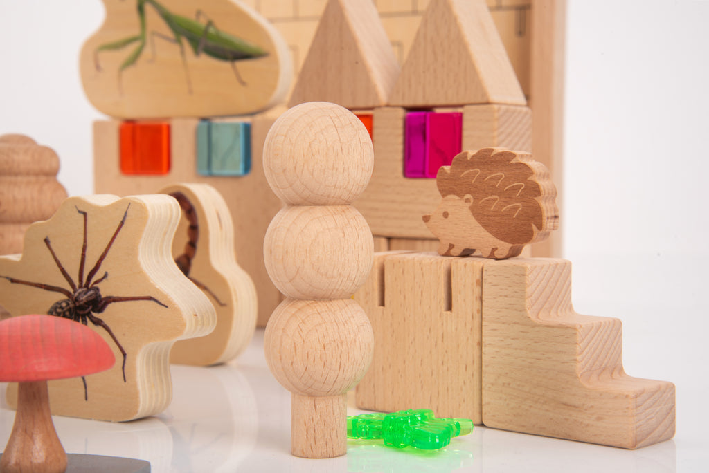 Wooden animal and forest-themed pieces, including hedgehog stand and stacked tree blocks
