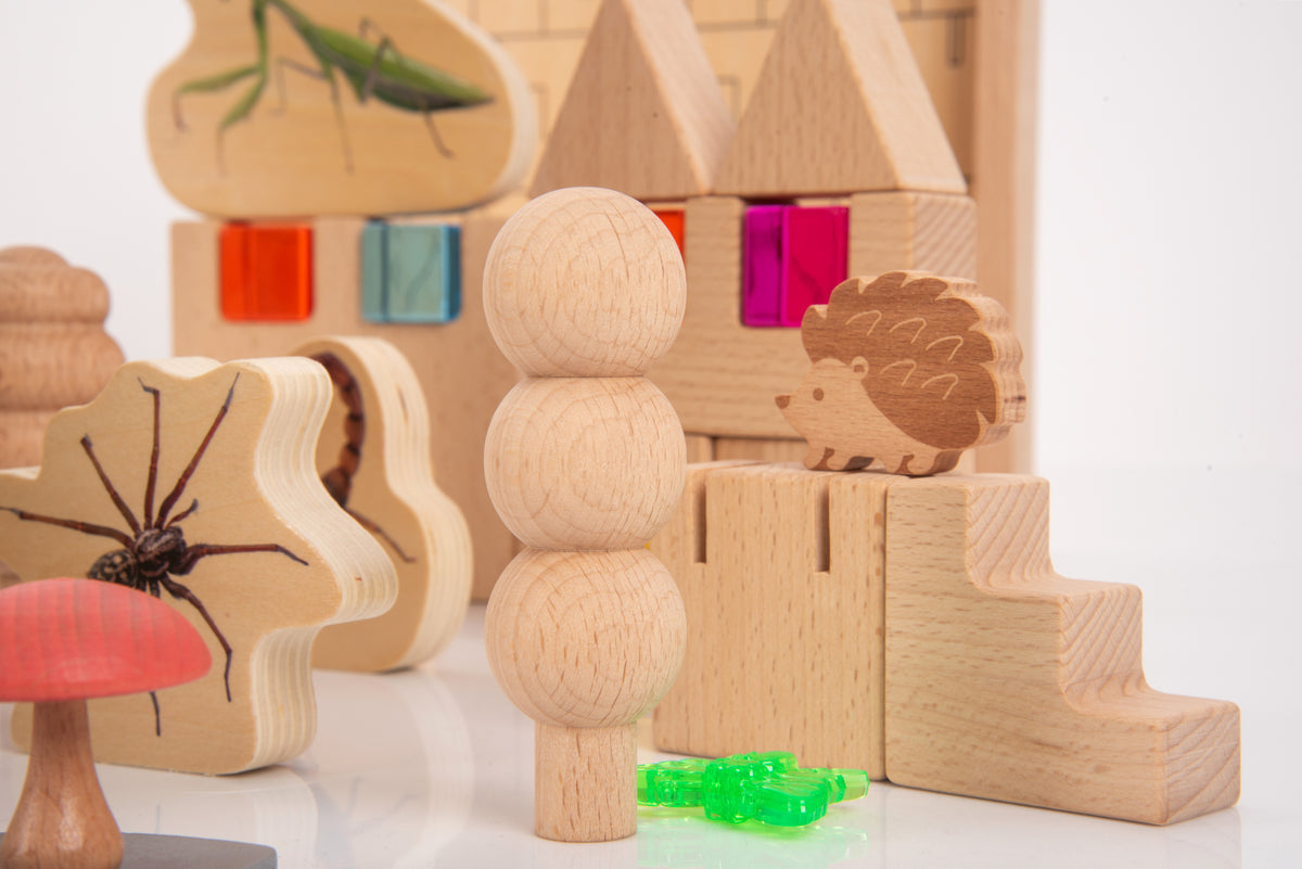 Wooden animal and forest-themed pieces, including hedgehog stand and stacked tree blocks