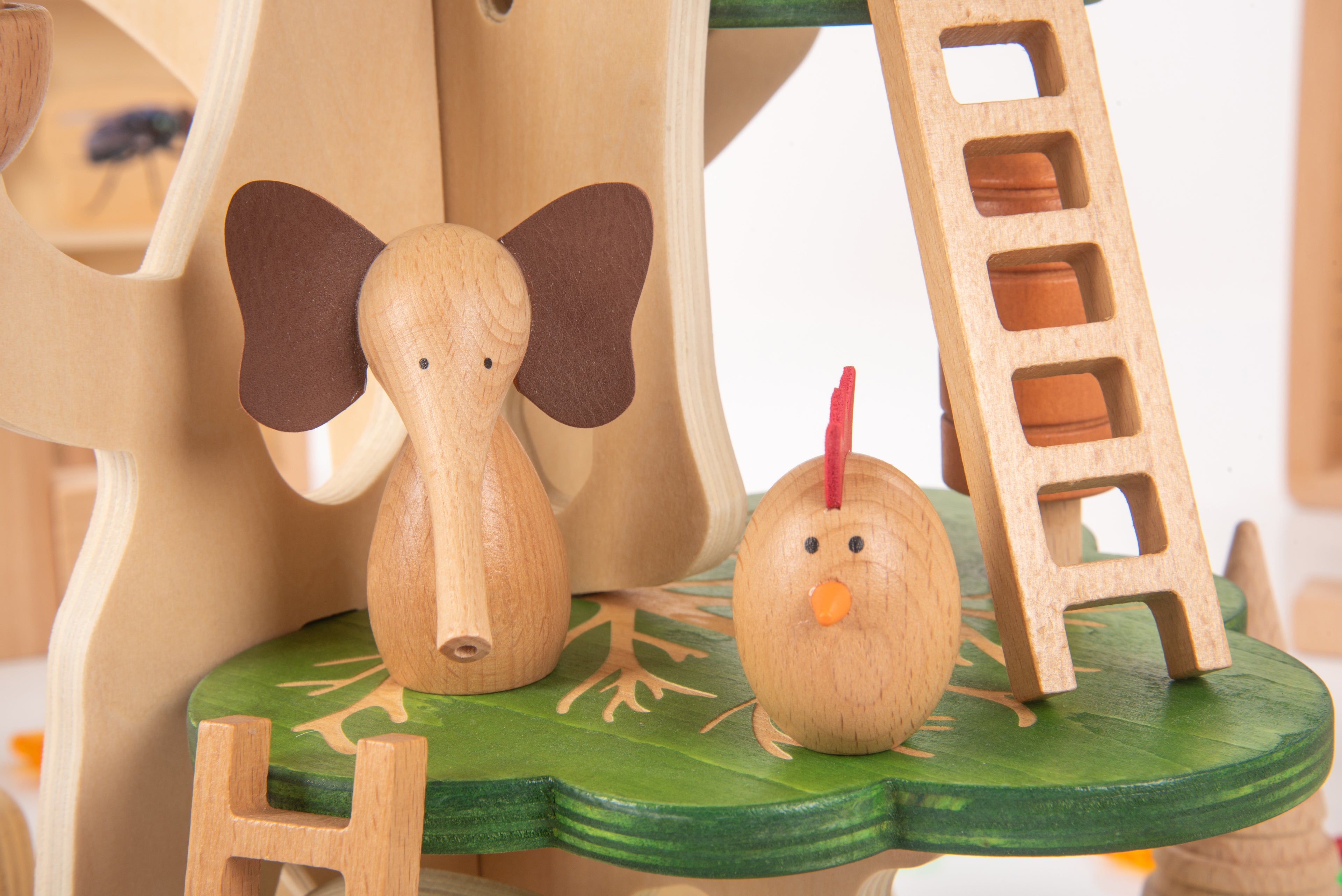 Wooden butterfly house with rabbit figure and small ladder on a green circular base