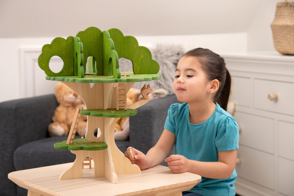 Wooden treehouse playset with green canopy, built-in platforms, and ladder