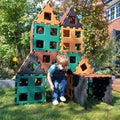 Interlocking natural color play blocks with square cutouts, forming a cube playhouse