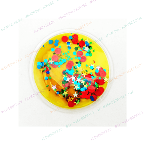 Sensory glitter disc with domed clear top, yellow base with bright multicolor stars and dots